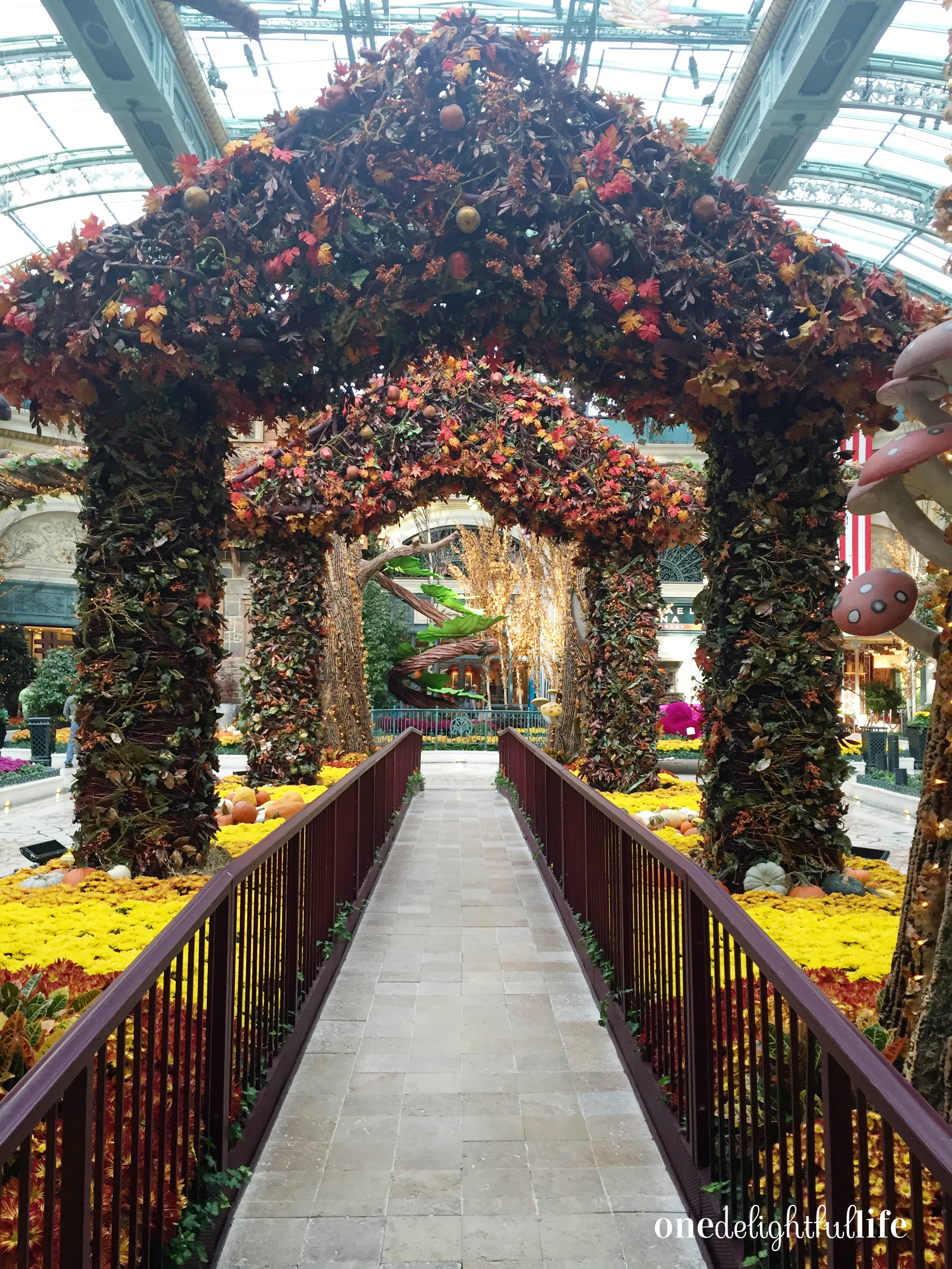 Main entrance to the conservatory gardens. Bellagio staff works on the flowers during early morning hours.