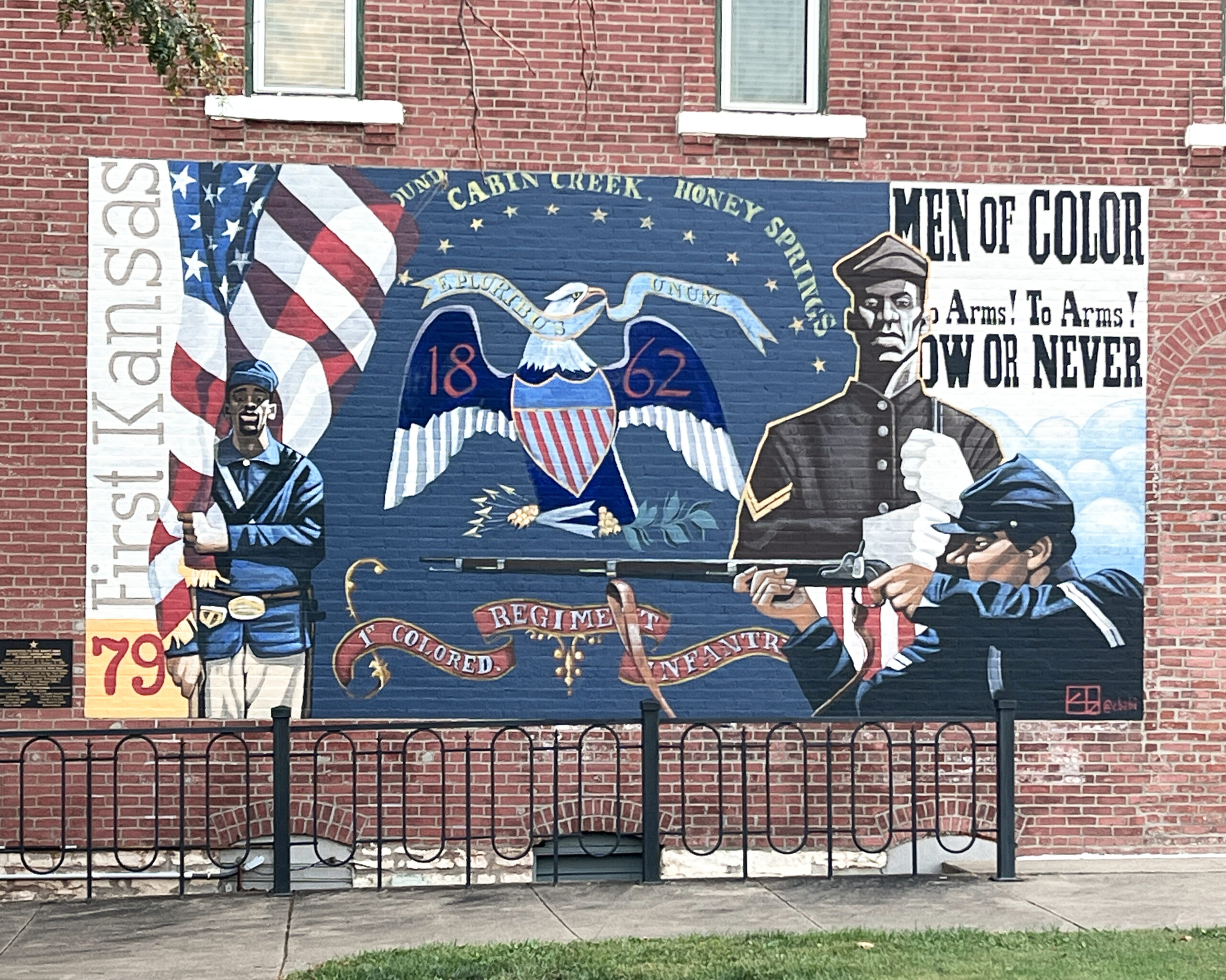 The First Kansas Colored Infantry Mural is located on the North end of Main Street, facing the Fort Scott National Historic Site, National Park at 1 Old Fort Blvd.