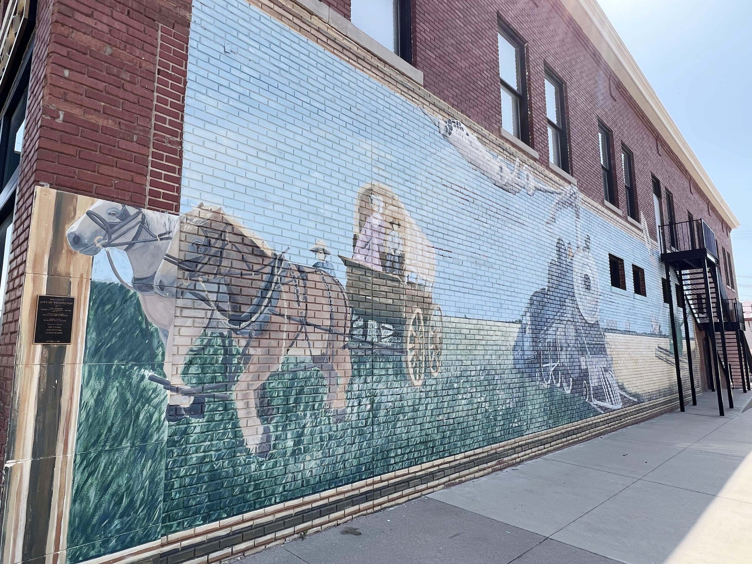 Artist Majorie Hall Bicker painted a scene depicting moments in Wellington's history around the corner from BeeHive Quilt Shop on 7th Street.