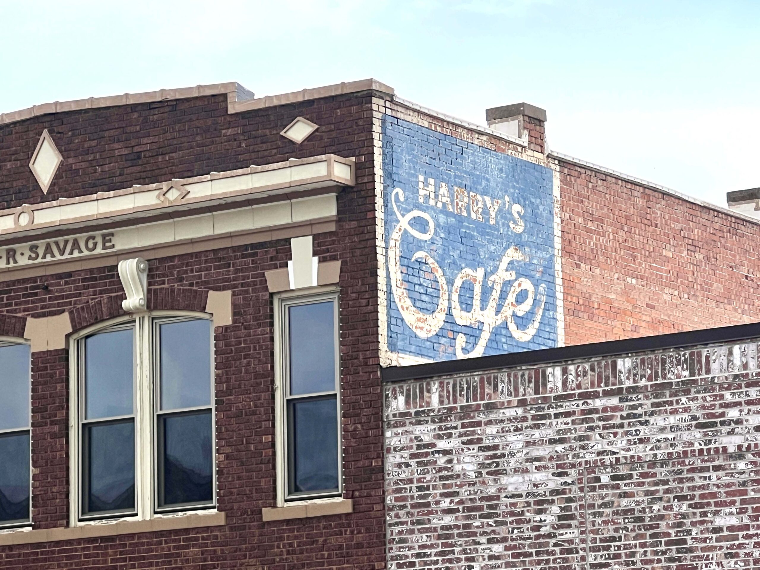Another ghost sign peeking out above a downtown roofline is the old Harry's Cafe mural. 