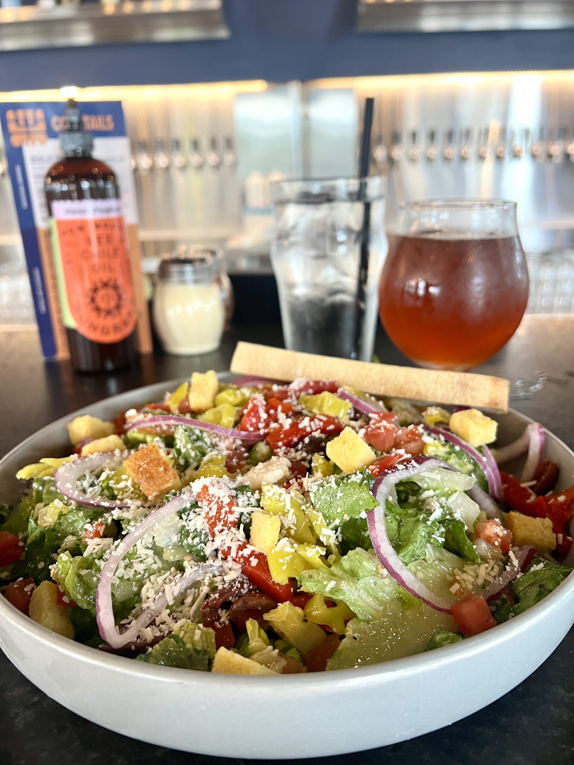 The Sungrano salad is served in an oversized bowl with pepperoncini and Focaccia croutons.