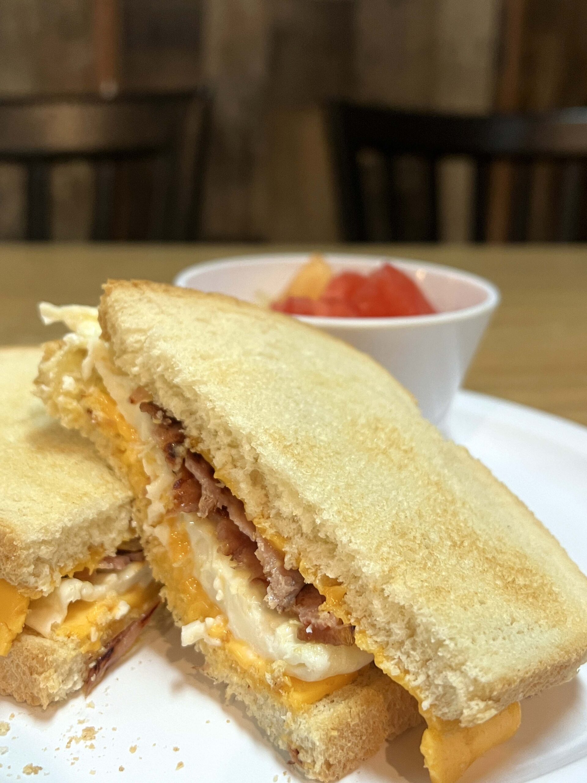 A breakfast sandwich with a cup of fruit is a lighter bite at the Farmhouse Cafe, known for hearty early-morning meals.