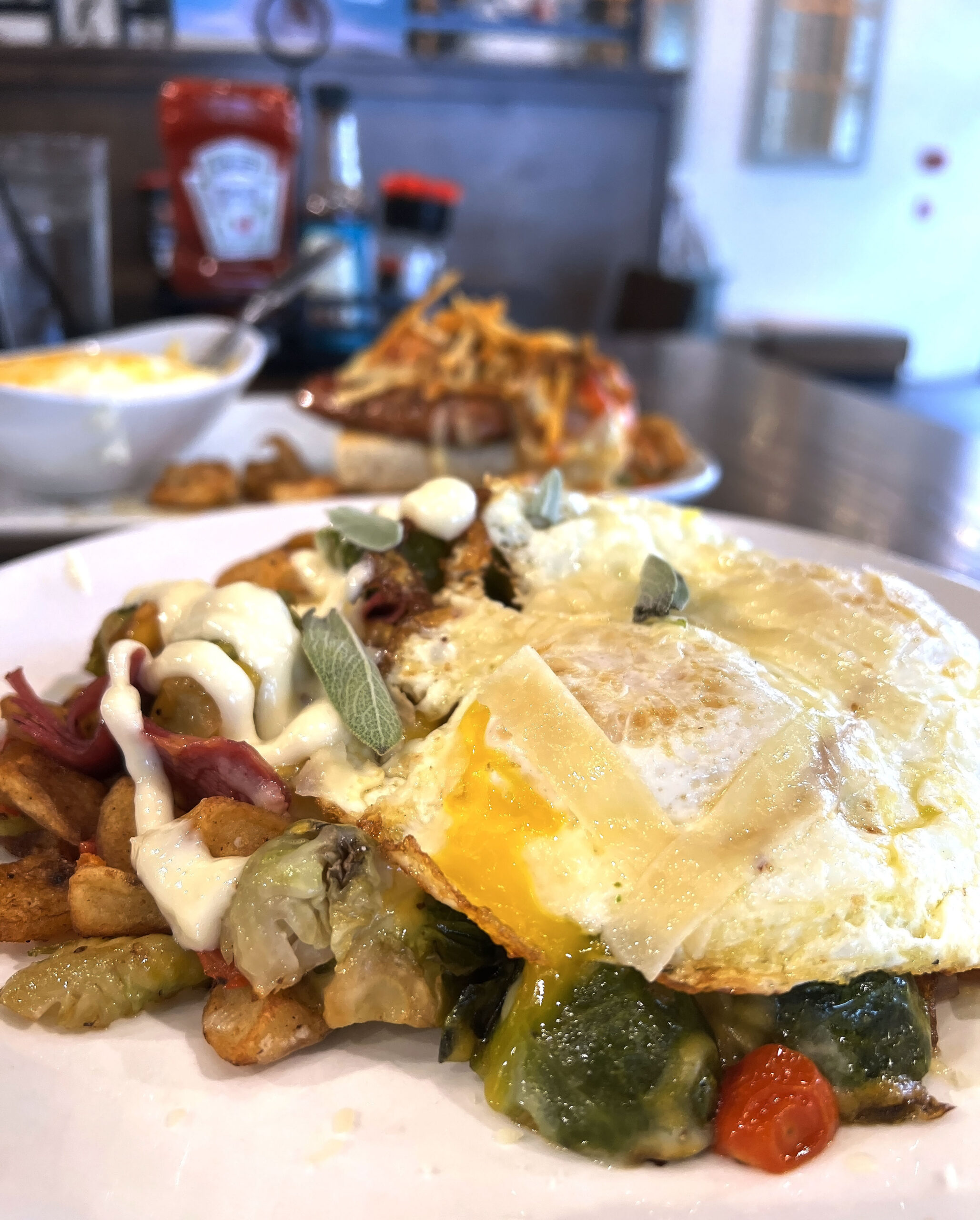 Corned Beef & Brussels Hash is a feature on Another Broken Egg Wichita's Fall seasonal menu featuring fresh vegetables and eggs cooked to your preference.
