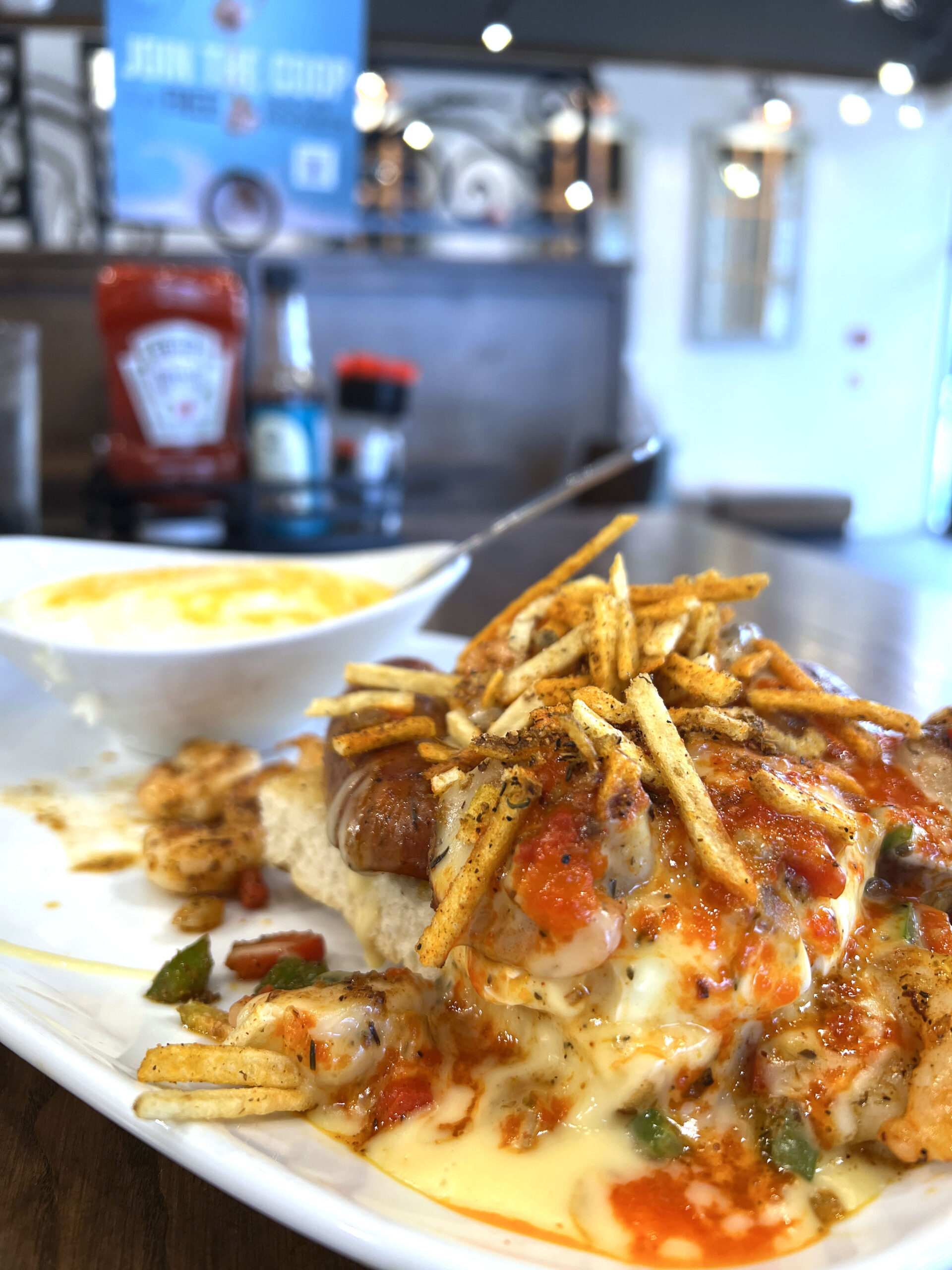 Louisiana Benedict is a fall seasonal menu selection served with spicy shrimp and topped with seasoned shoestring potatoes.