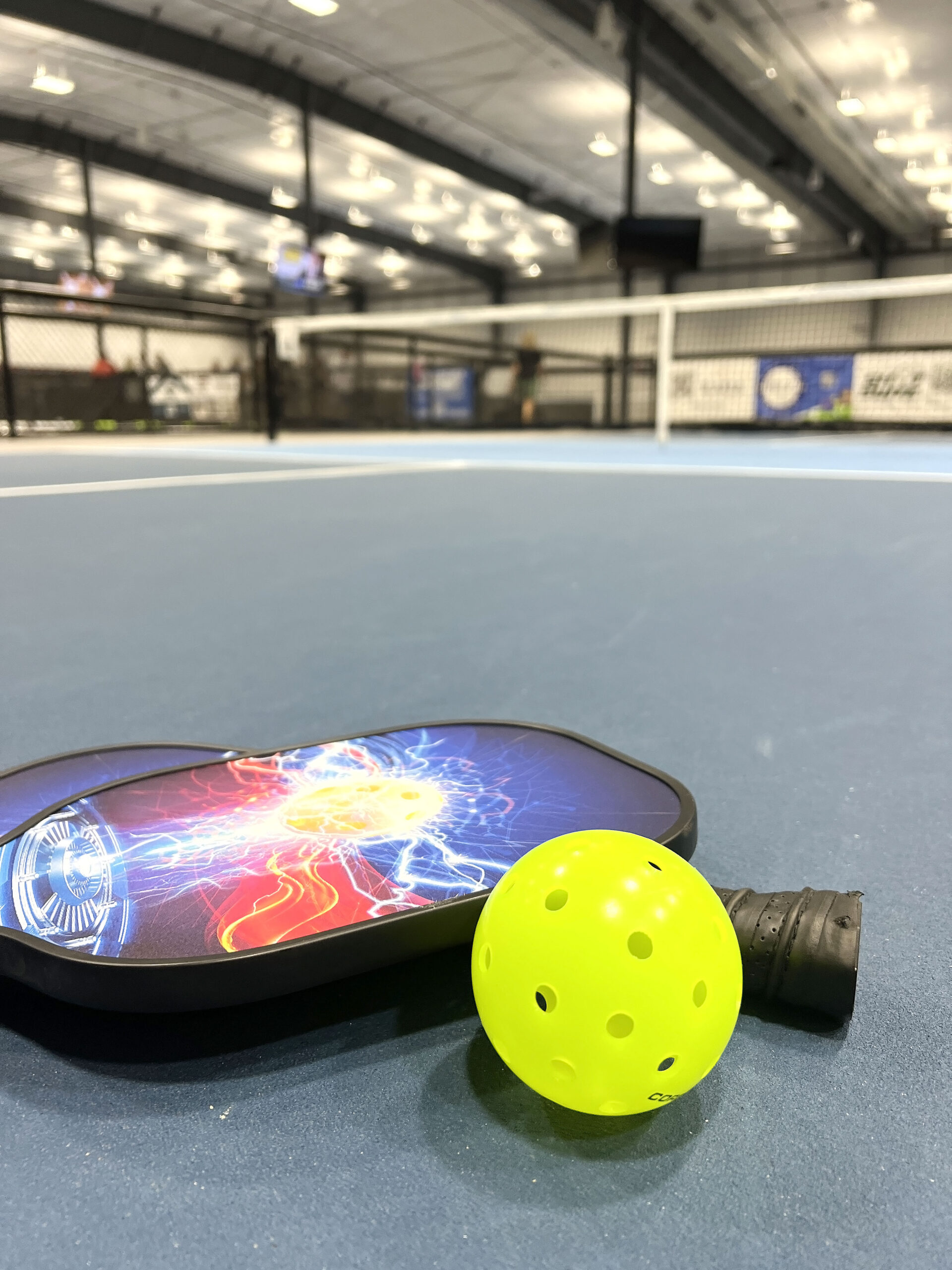 Pickleball Paddles and Ball on a court at TapNPaddles.