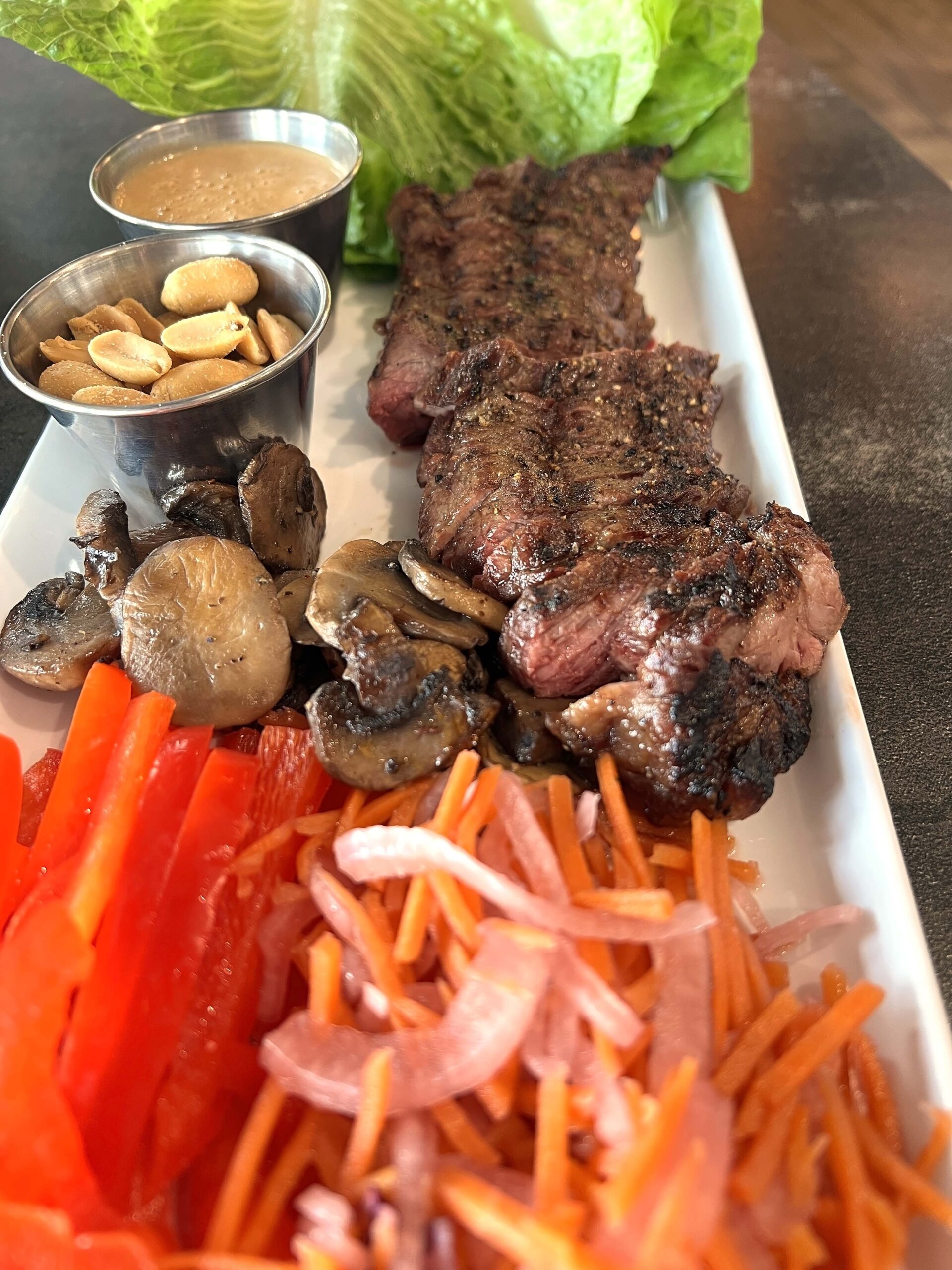 The Steak Lettuce Plate is a shareable starter served with bavette steak and vegetables to eat with lettuce leaves.