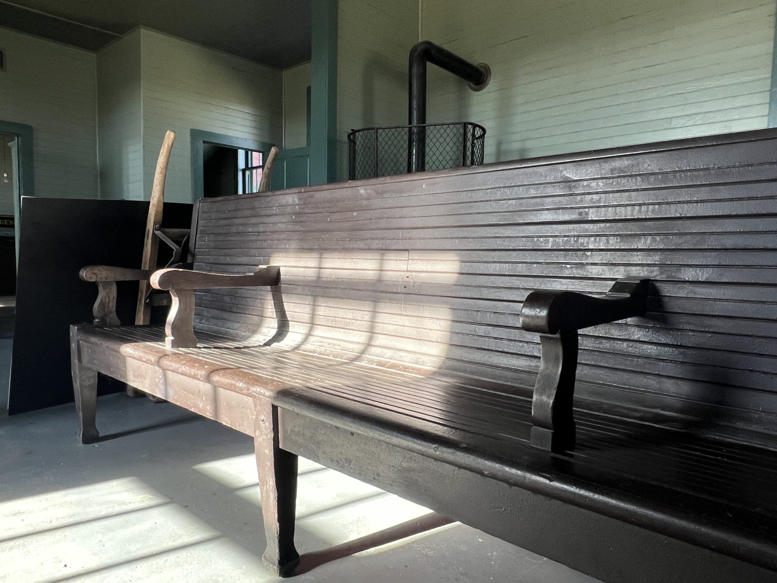 Original Burlington Depot benches are illuminated by the sunshine.