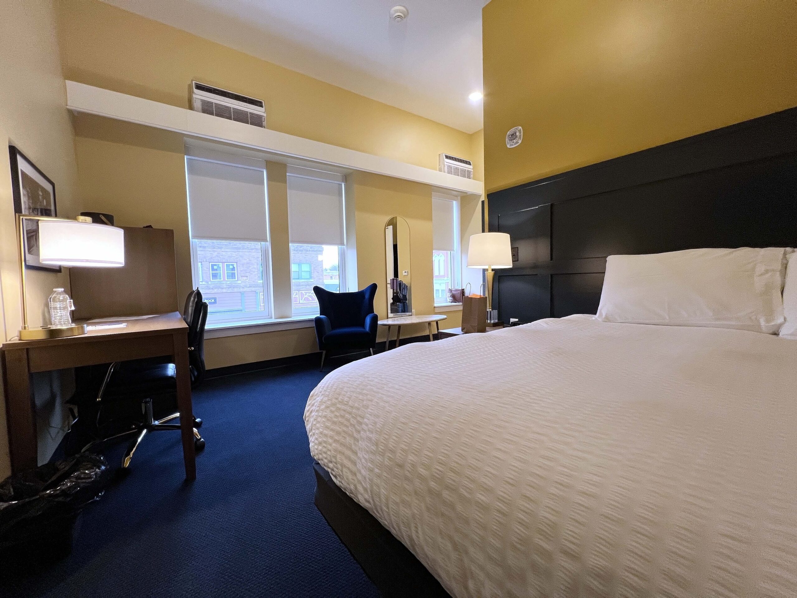 King Bedroom facing downtown's main street includes a bathroom with a shower and work station desk area.