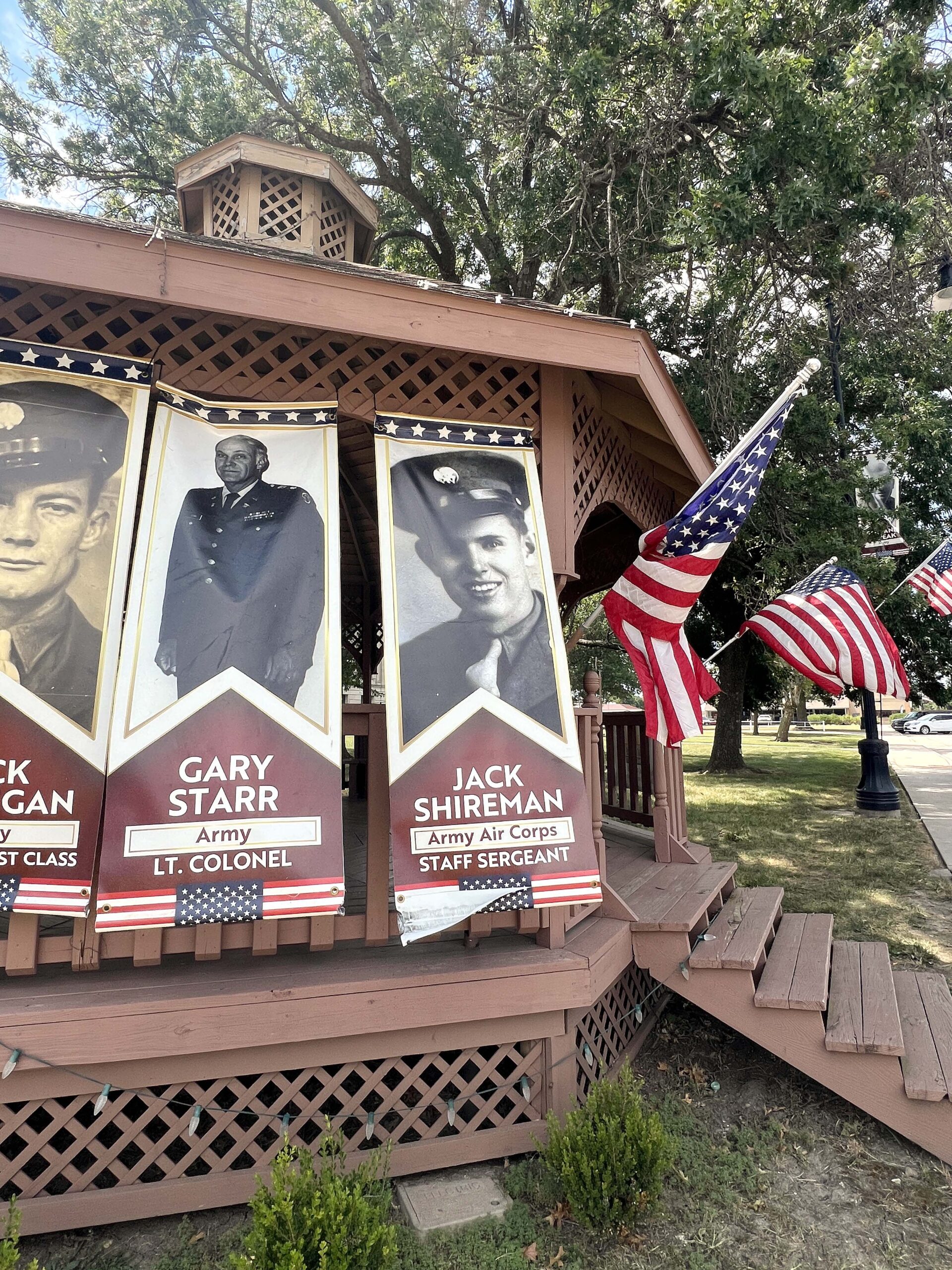 The courthouse's outdoor gazebo is adorned with banners honoring local veterans. 
