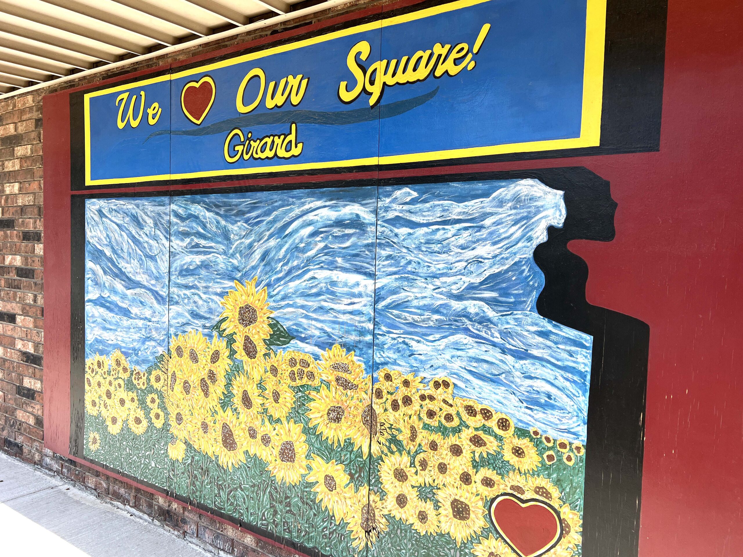 The We Love Our Square "sunflower mural" is a photo-worthy shaded area.