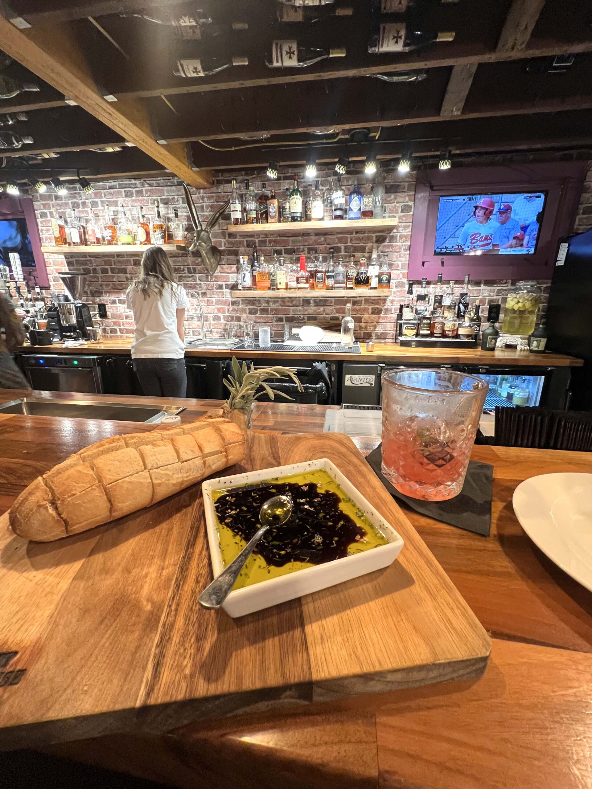 Breads with dipping oil and a cockail