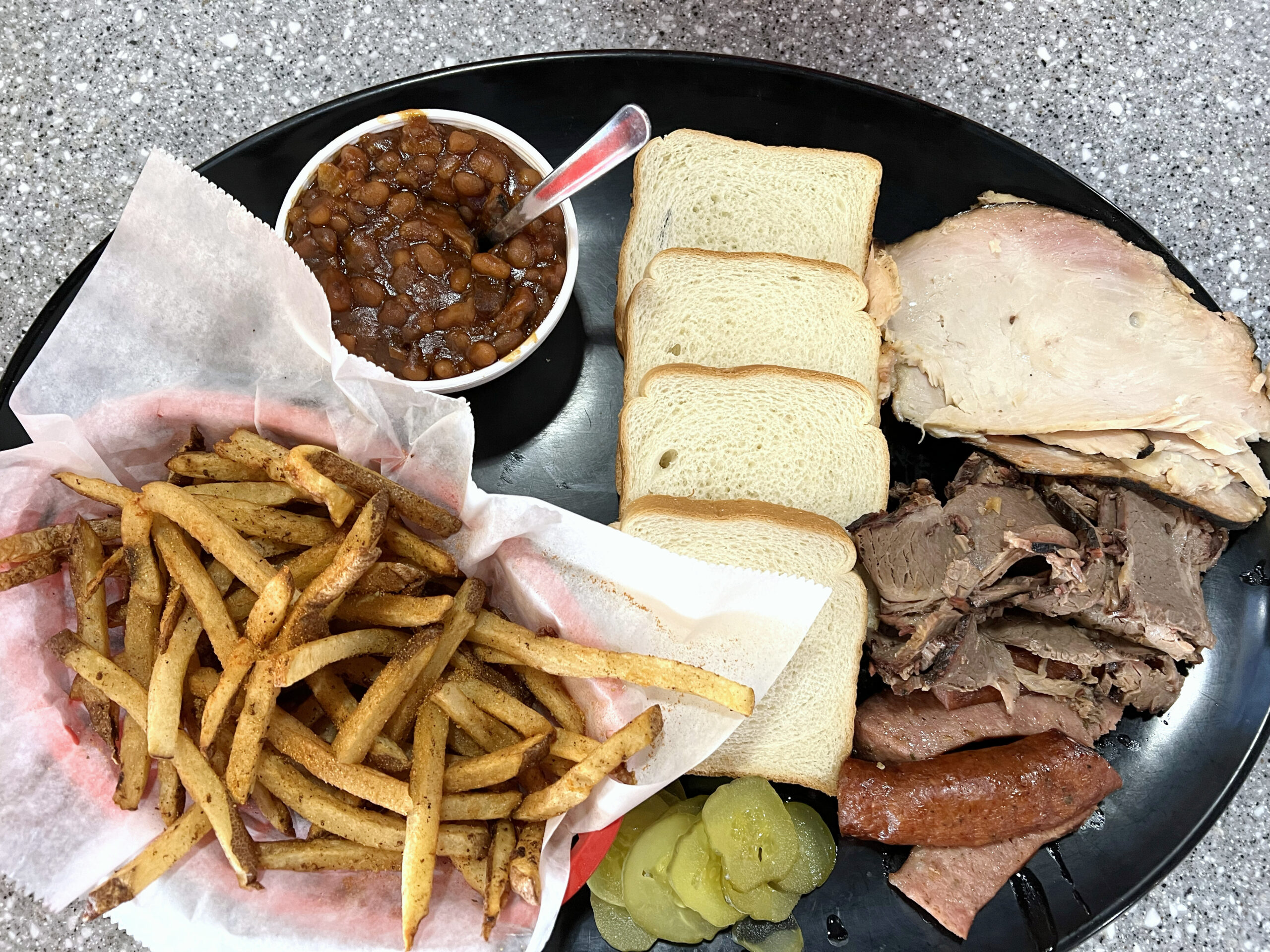 Smoked Creations BBQ in Ottawa, Kansas, served slow-smoked meat with traditional sides like baked beans and French fries. 