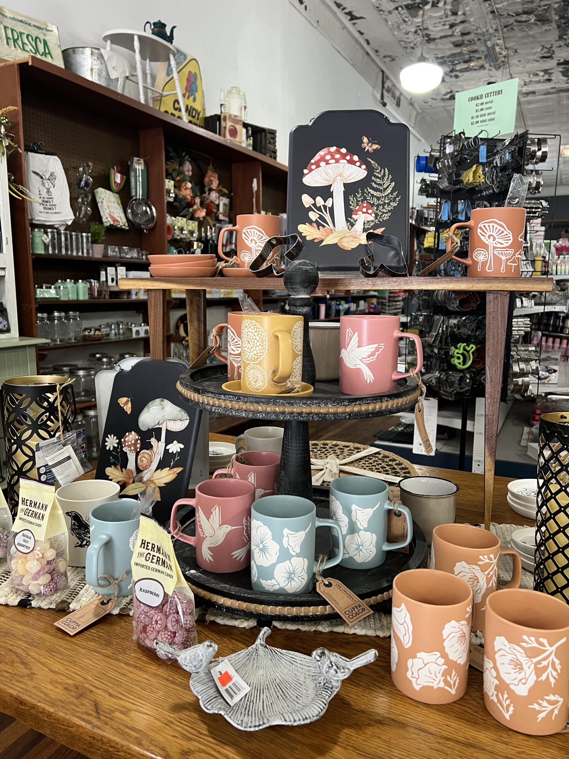 Mushroom-themed mugs are displayed amongst kitchen supplies at Holton Mercantile.