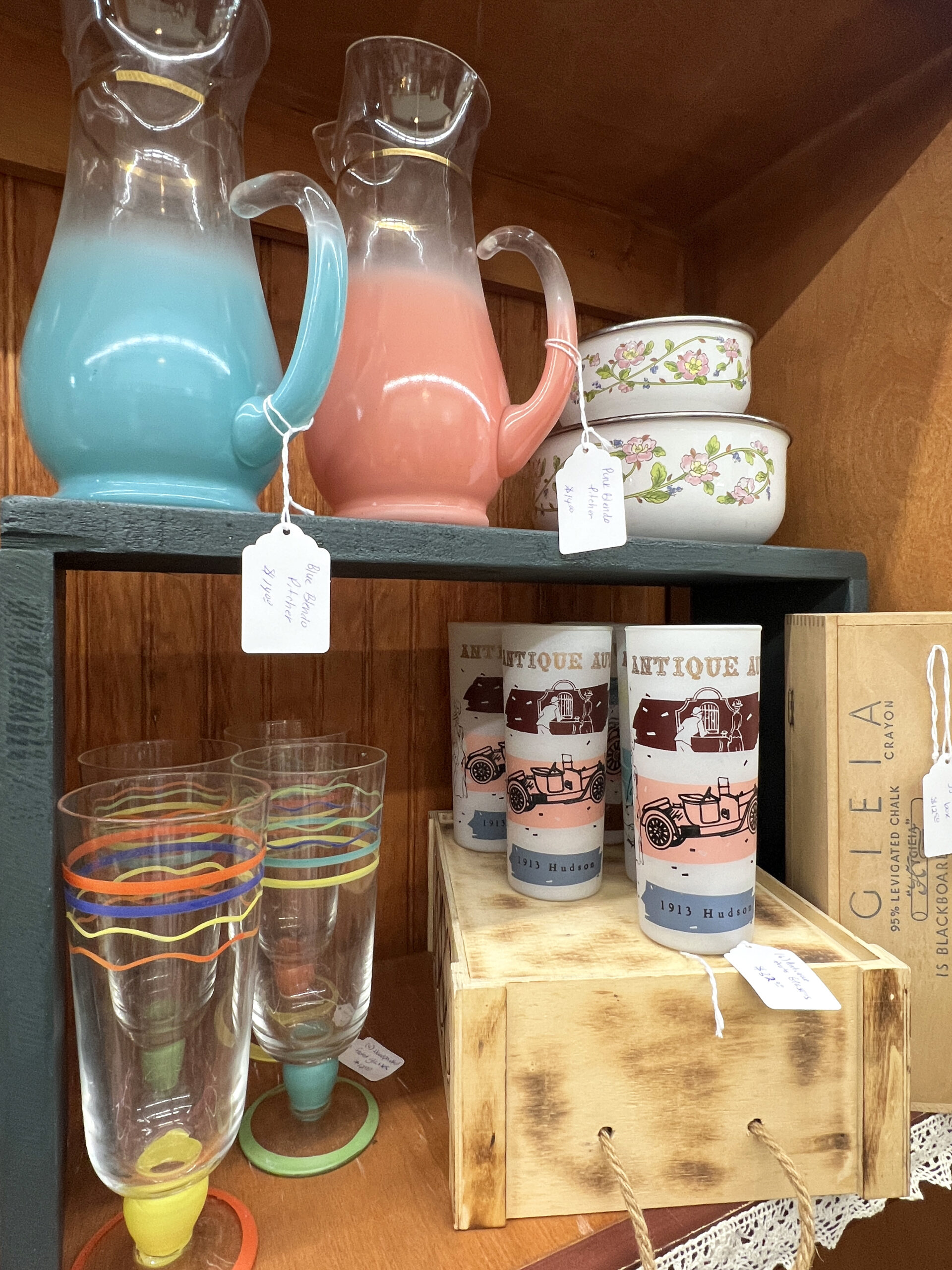 Retro glassware sits upon a shelf of a vendor's booth at 785 Antiques in Holton, Kansas.
