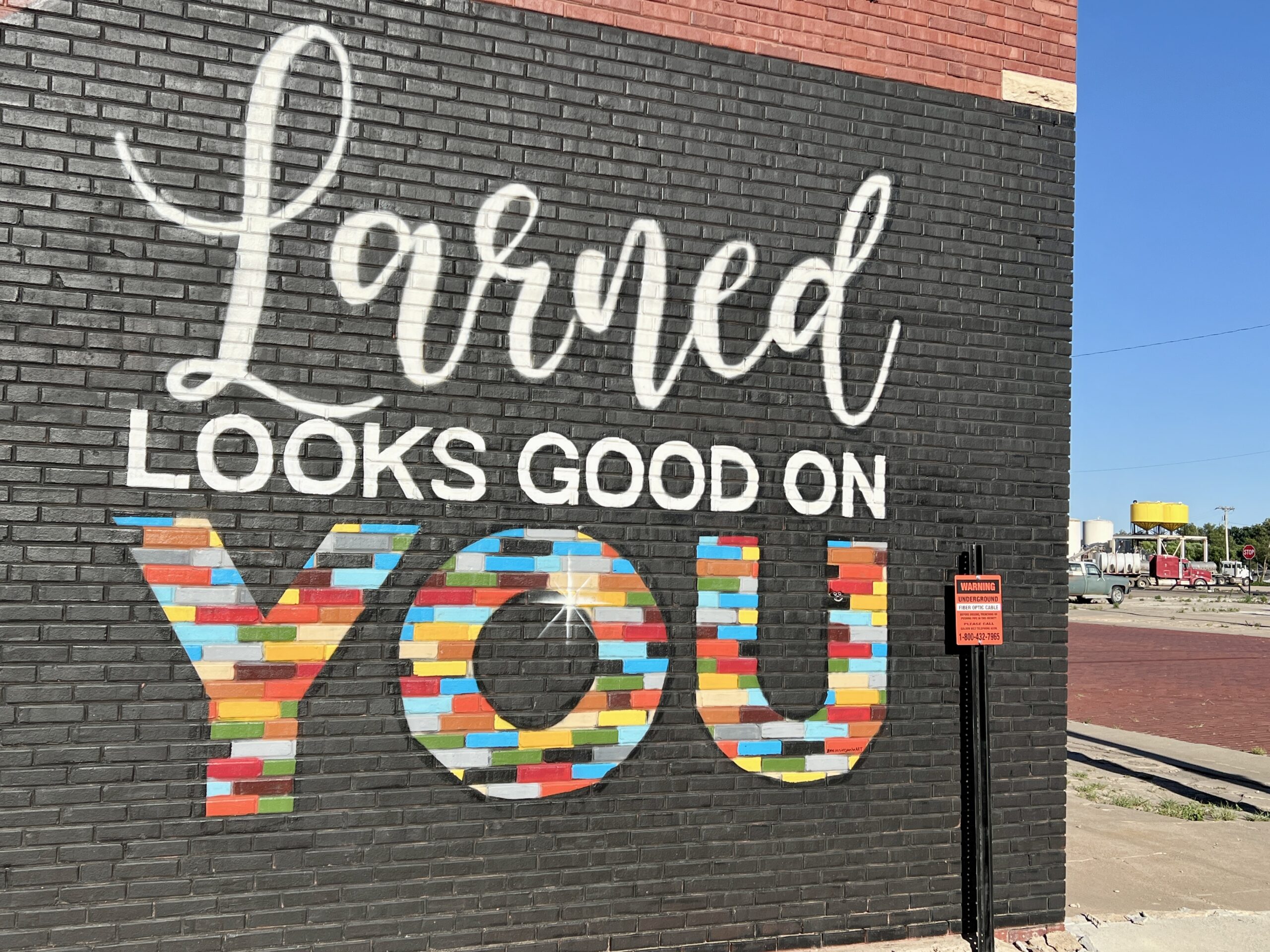Larned Kansas murals peek out from alleyways in downtown.
