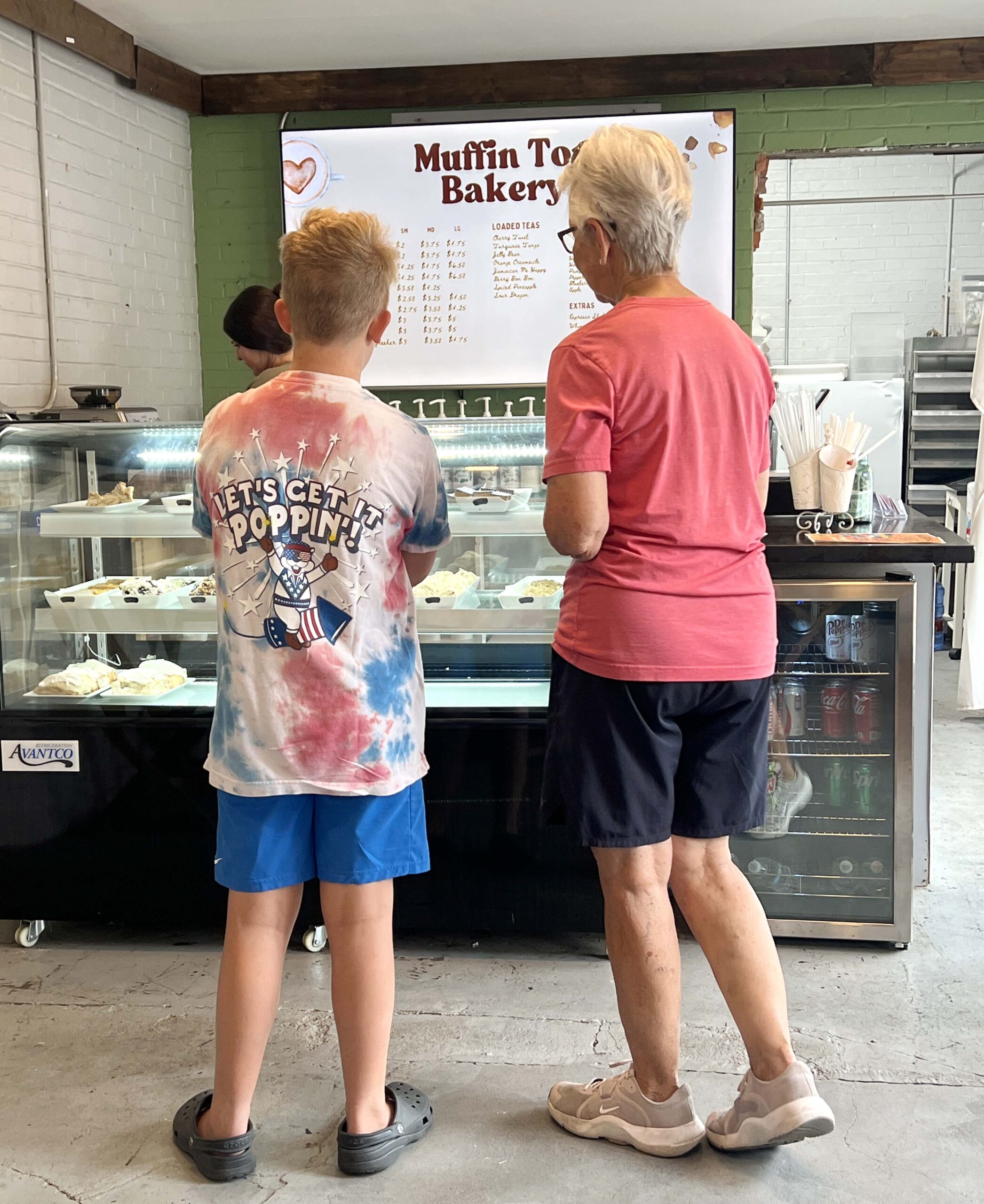 A grandmother and her grandson arrived while I sat at a cafe table awaiting my prepared to-go order.