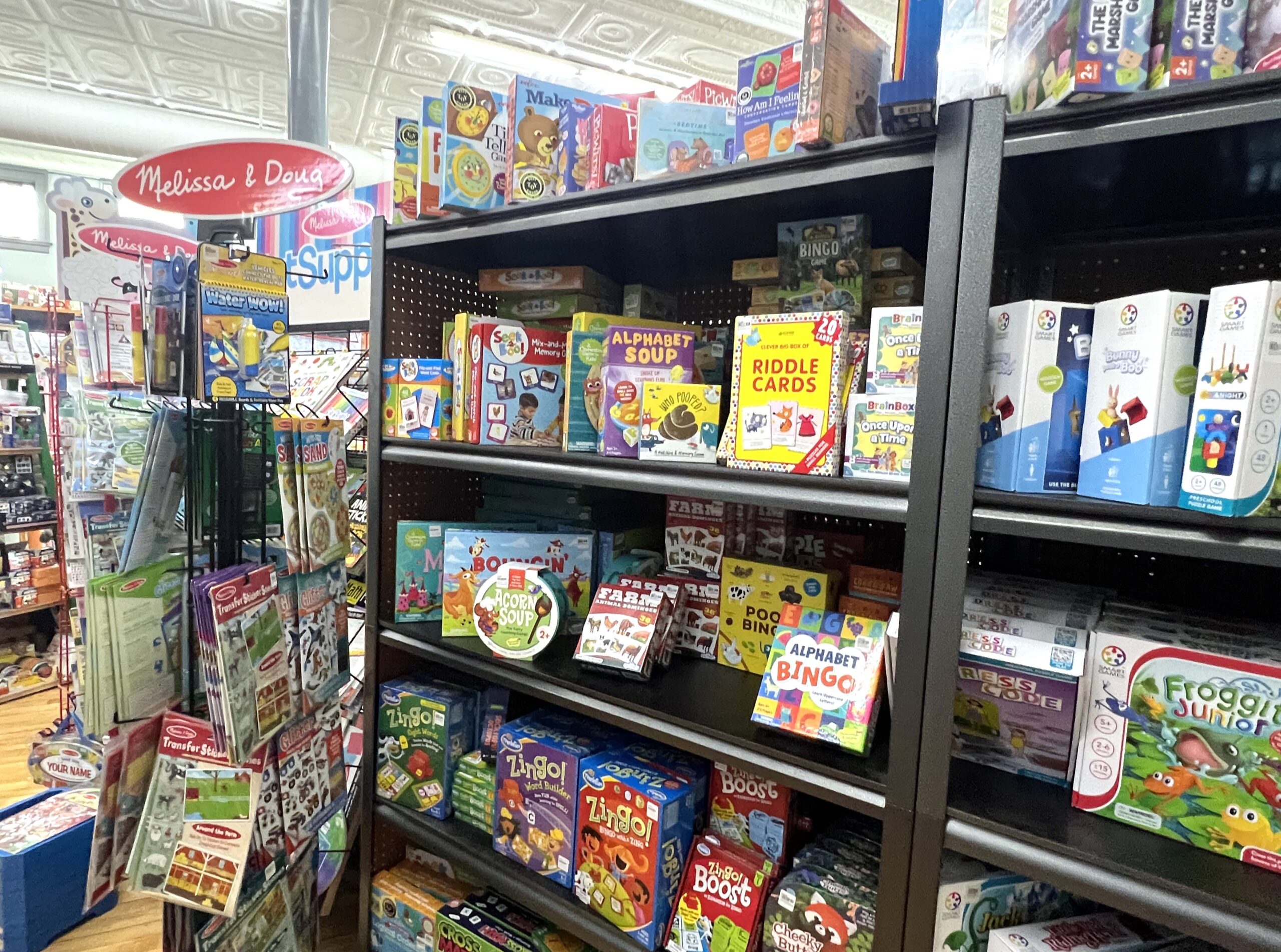 Boxed games and toys are for sale at Bee Creative. 