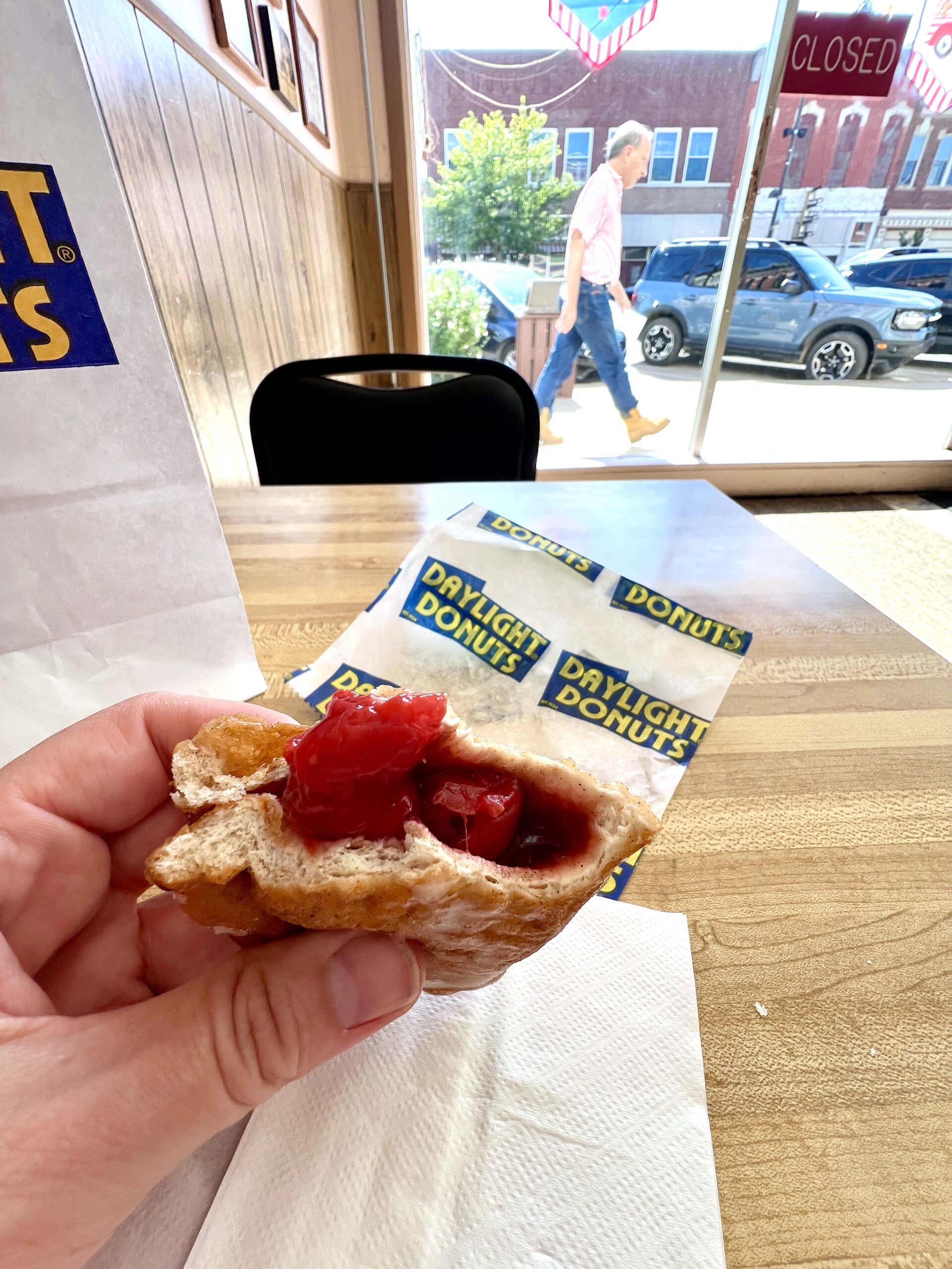 Wood-paneled walls with framed photography of local happenings adorn the space. The smell of fresh-baked glazed donuts, bear claws, and long johns filled the air of the family-owned shop.