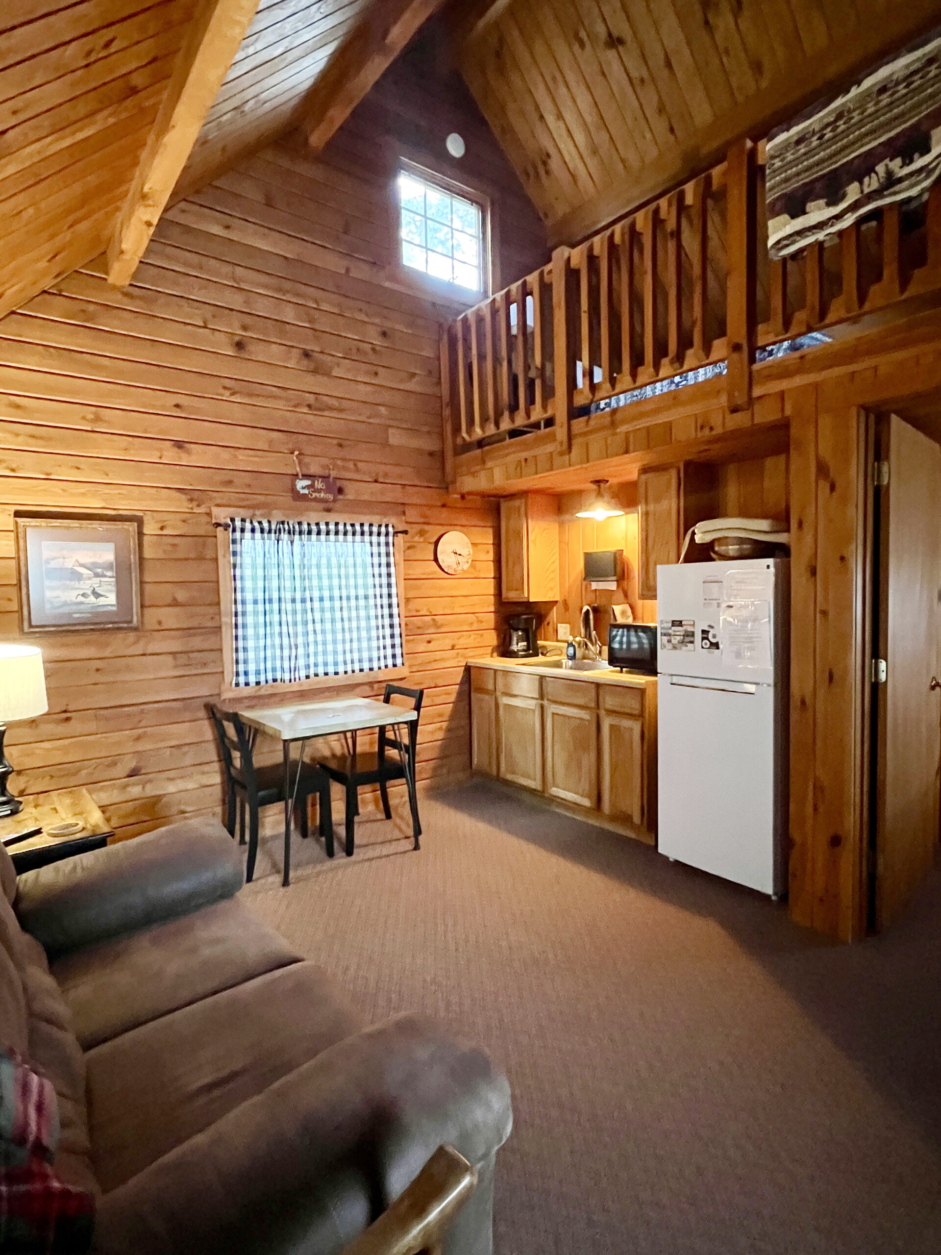 The interior view of Cabin 1 at The Country Cabin features an open kitchen, dining, and living room floor plan.