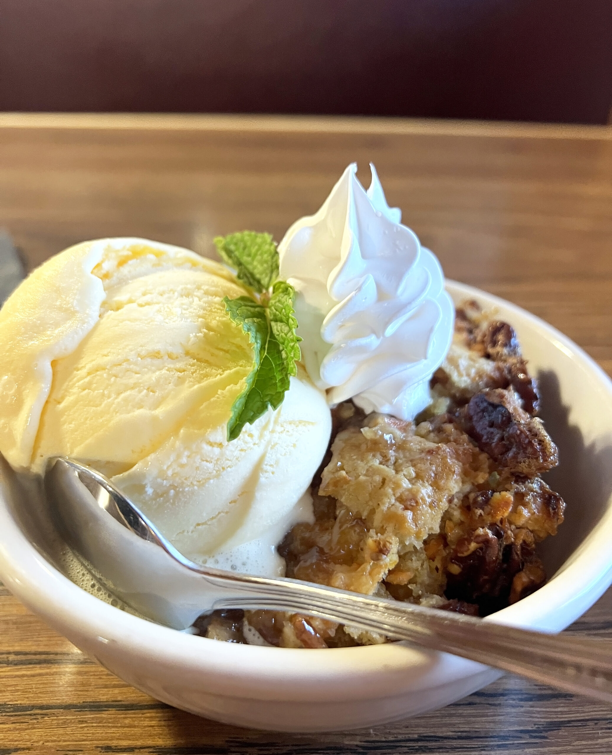 Carrot Cake Cobbler is served with vanilla ice cream. 